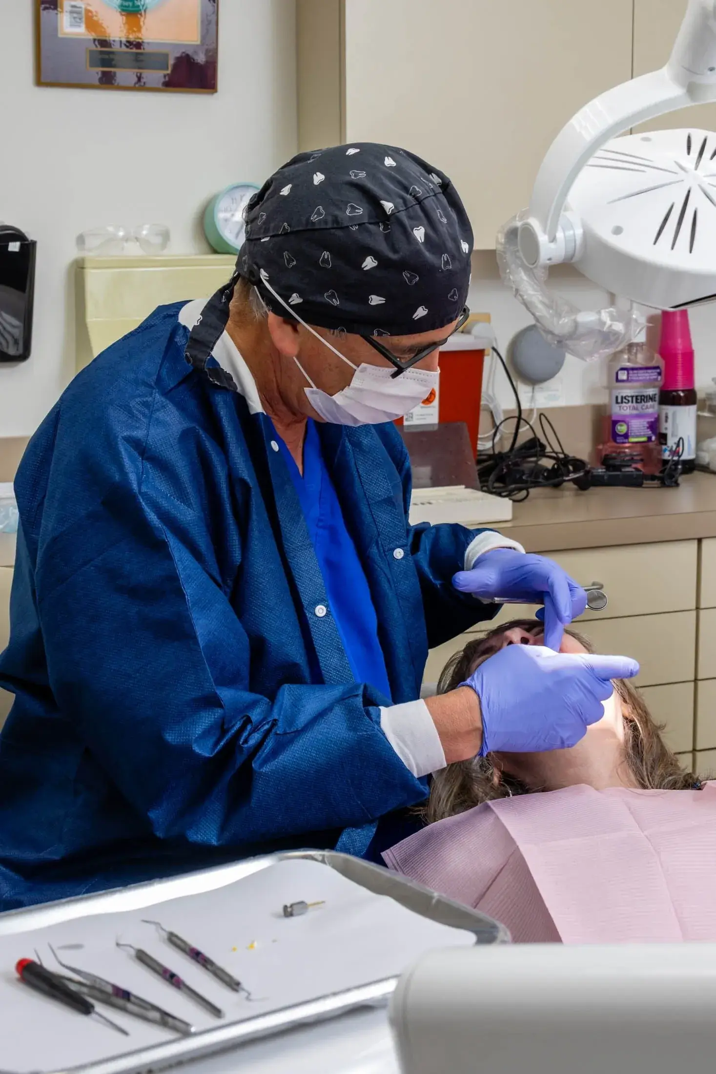 Dentist examining patient in dental office.