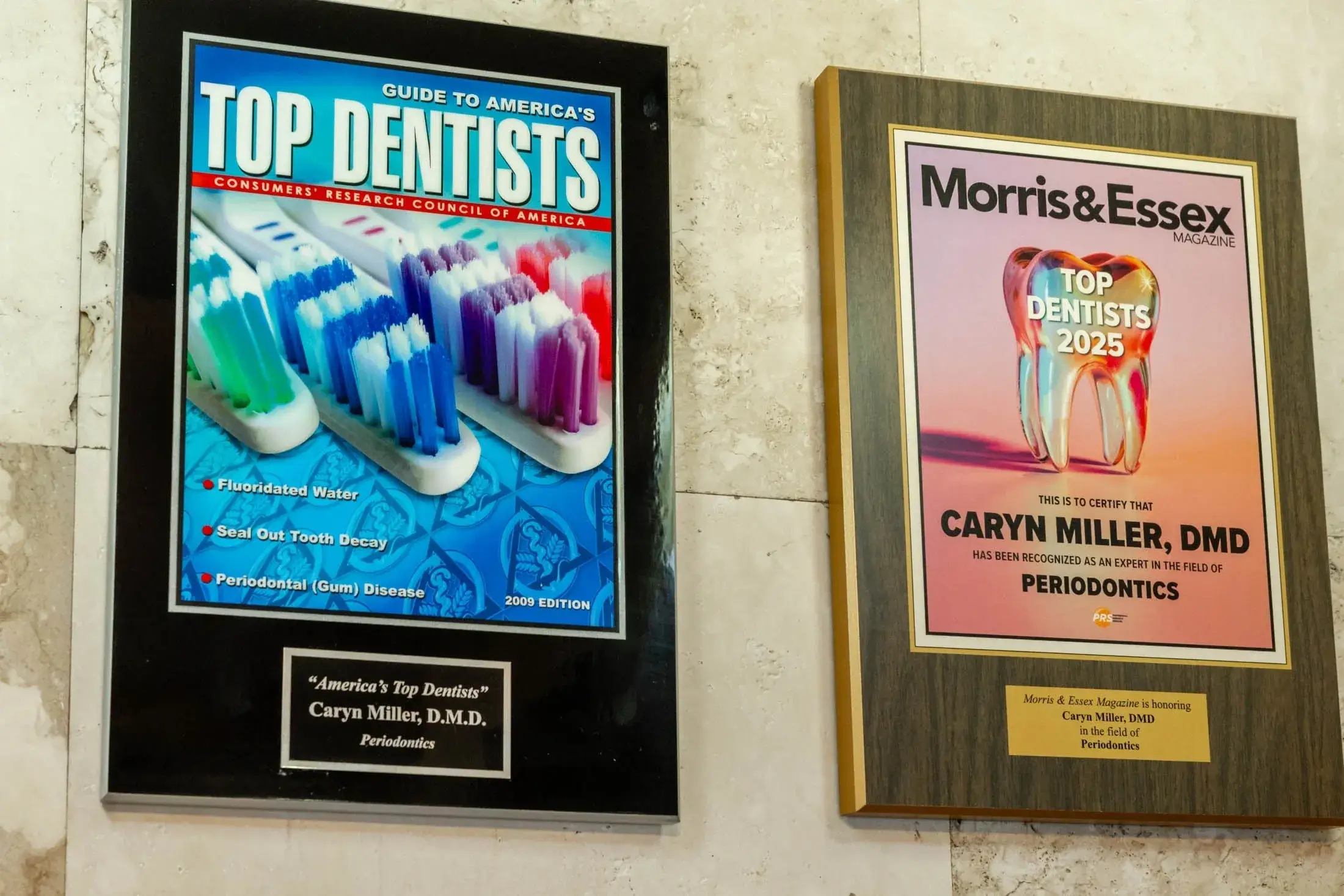 Dental awards displayed on a wall plaque.