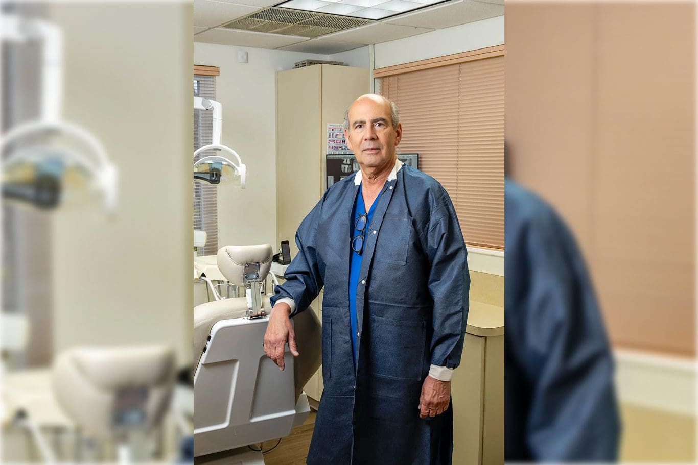Dentist standing beside dental chair
