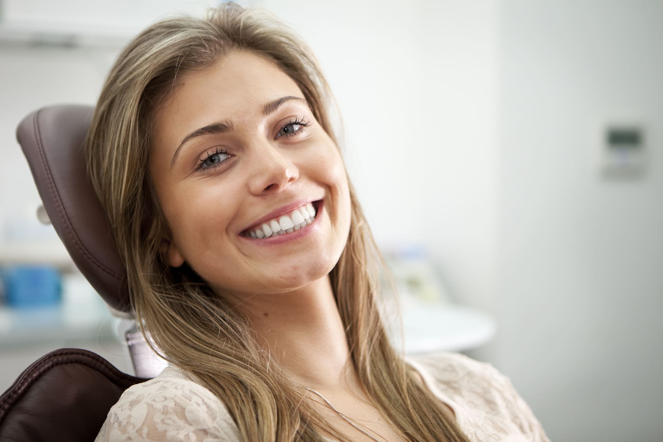 Young woman smiling in dentist's chair